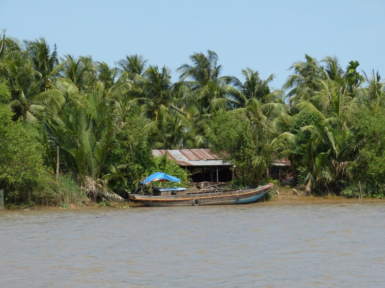 A house sits on the edge of the Mekong River.