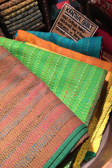 Shopping for hand-dyed fabrics at Maiwa Handprints in the Net Loft on Granville Island. Vancouver, Canada