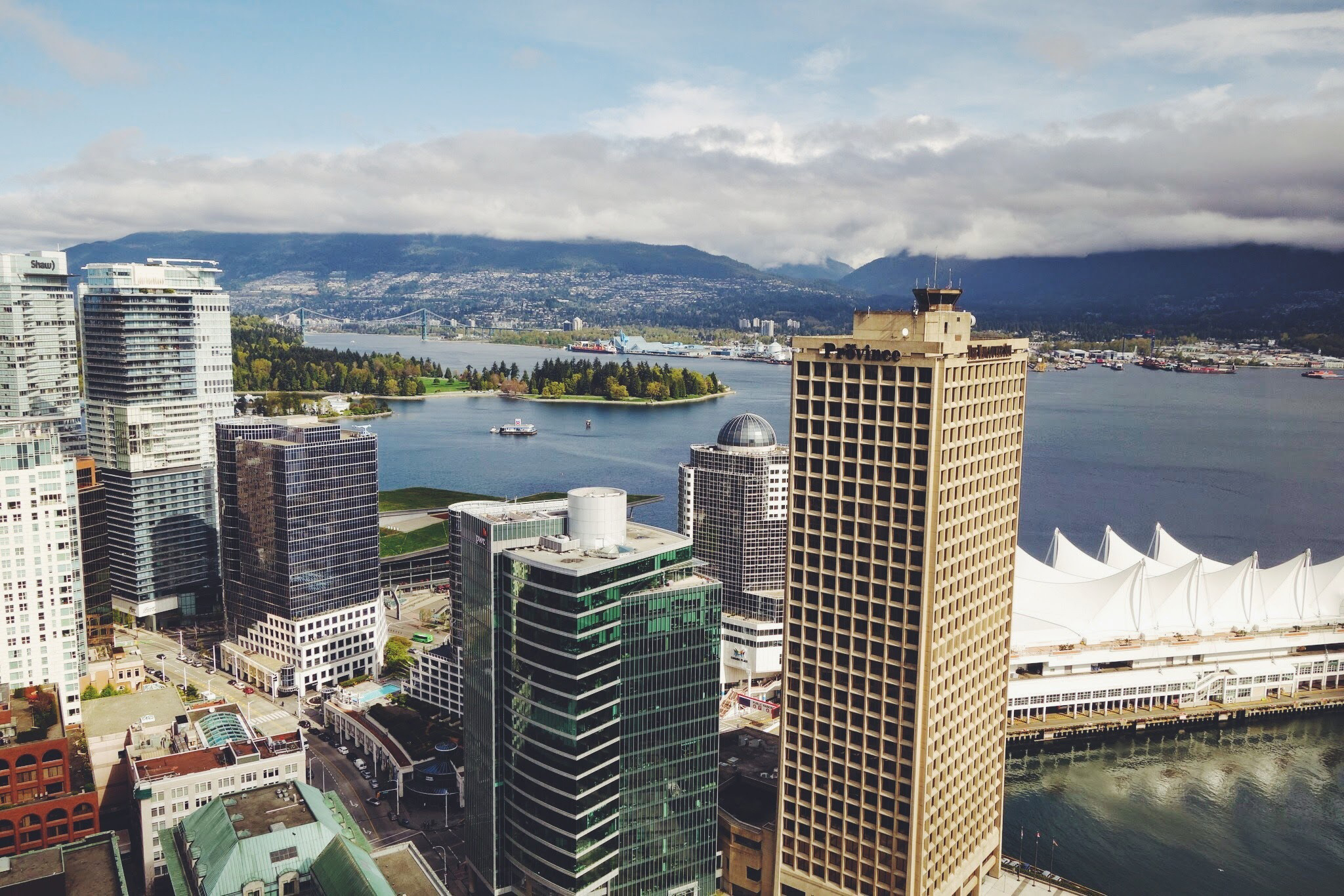 Looking across the highrises of Vancouver to Burrard Inlet and North Vancouver's mounains. Canada