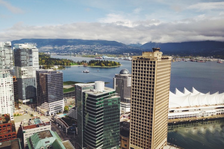 Looking across the highrises of Vancouver to Burrard Inlet and North Vancouver's mounains. Canada